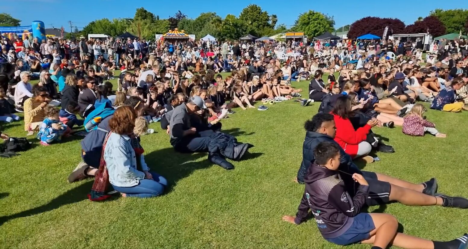 A wide view of the festival lawn full of people