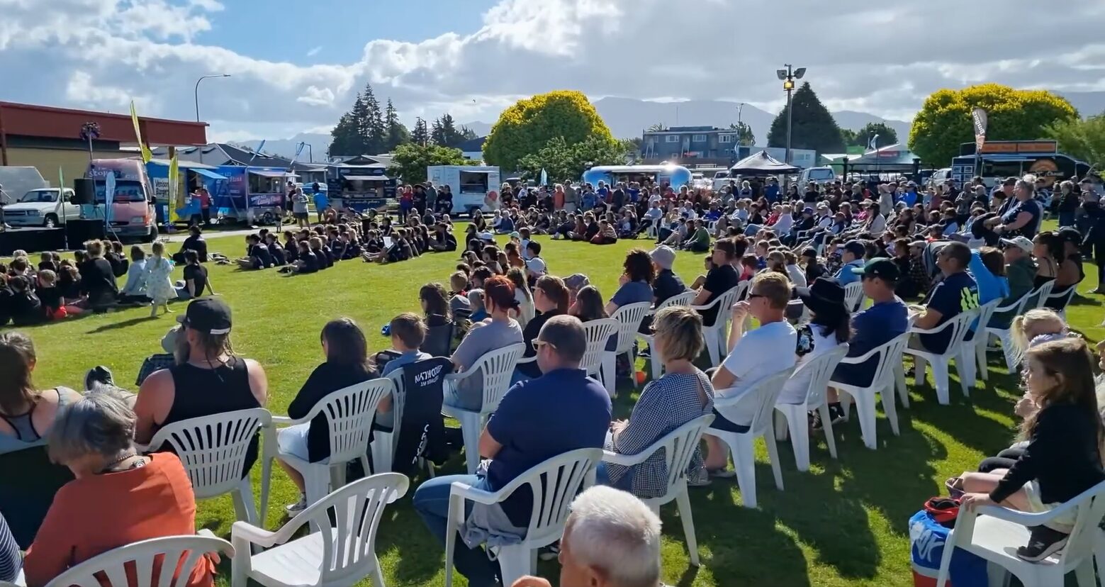 A big crowd seated in front of the main stage