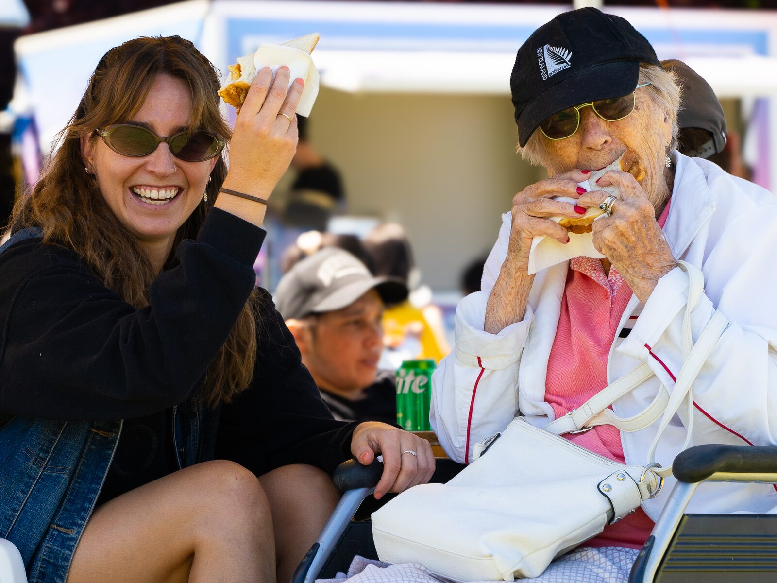 Two friends laughing together over festival kai
