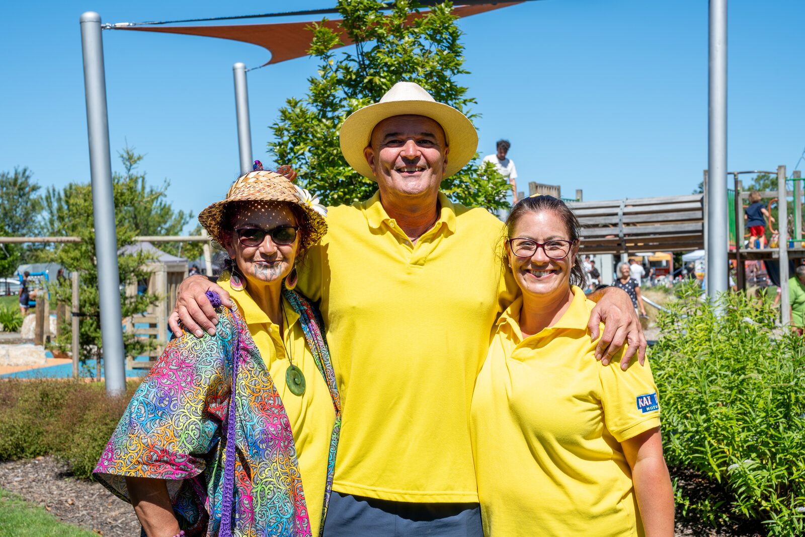 Volunteers in yellow shirts with a festival-goer